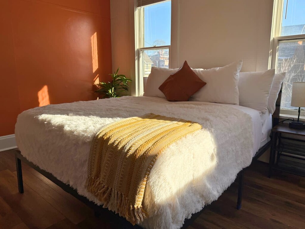 Soft linens, extra pillows, and a touch of elegance make this bedroom a true retreat from the everyday hustle