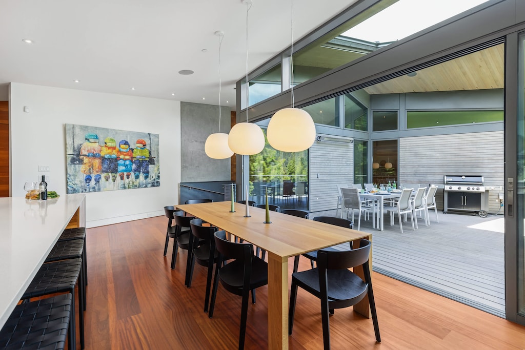 - Sleek dining space opening onto a private deck  
- Warm wood tones paired with modern lighting design  
- Perfect flow for indoor-outdoor mountain dining 