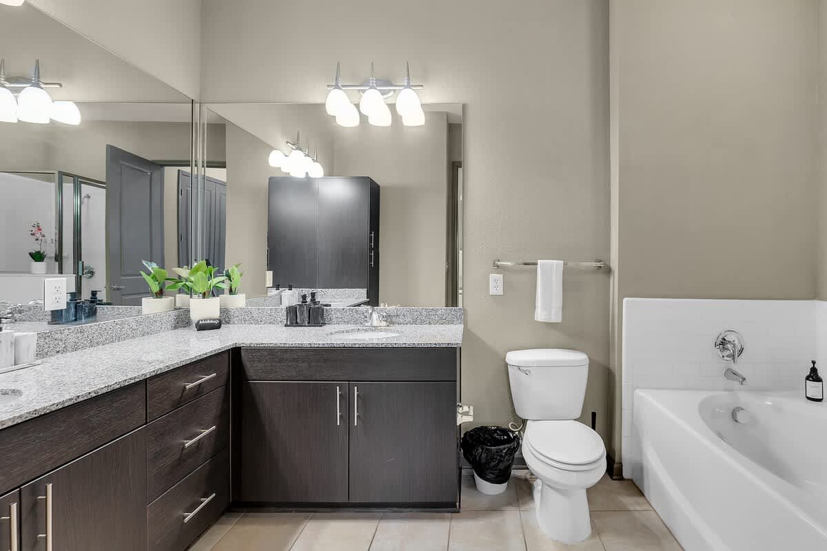 Relax and unwind in our full bathroom featuring a luxurious bathtub, modern vanity, and toilet.