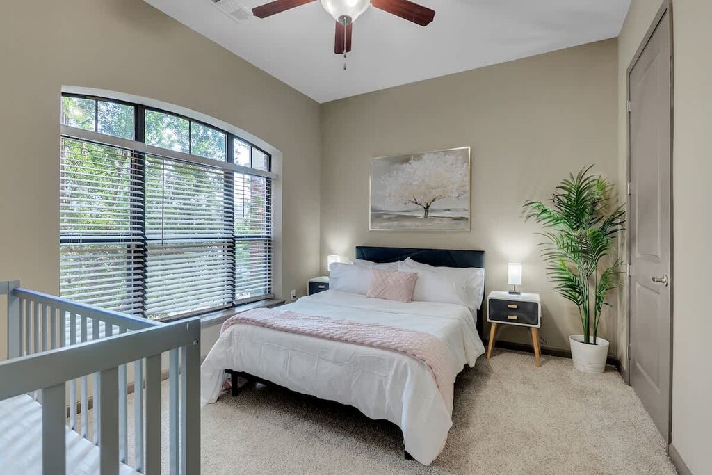 Designed for comfort and convenience, the bedroom includes a TV for entertainment and a dedicated workstation for work.