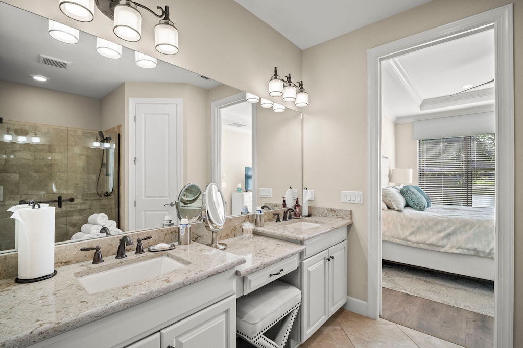 Main bathroom dual sinks off of king adjustable bed