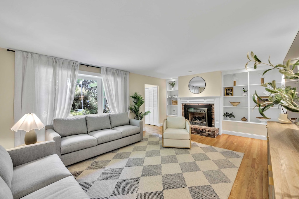 Centered around a charming brick fireplace and custom built-ins, the living room is as cozy as it is elegant.