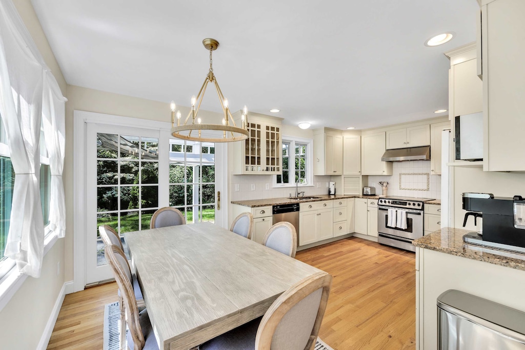 The kitchen opens directly to the outdoor patio, perfect for summer cookouts or morning coffee al fresco.