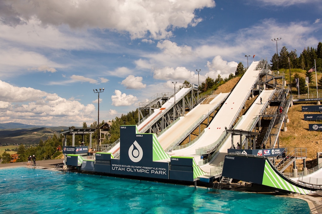 Utah Olympic Park's iconic ski jumps overlook training pools, showcasing the area's Olympic heritage and mountain recreation legacy.