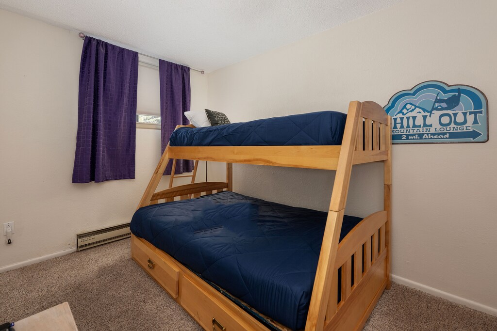 Your family will love this cozy bunk room with comfortable bedding and fun mountain-themed decor creating the perfect space for kids.