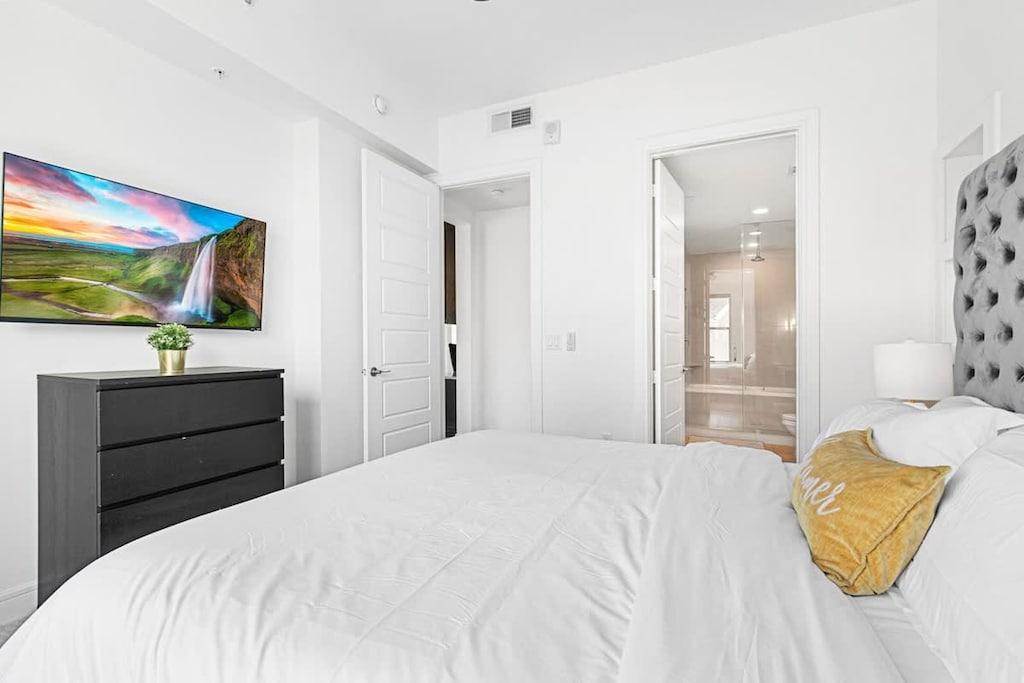 Chic Bedroom Retreat: Modern elegance awaits with a plush king bed and stunning views - your escape starts here!