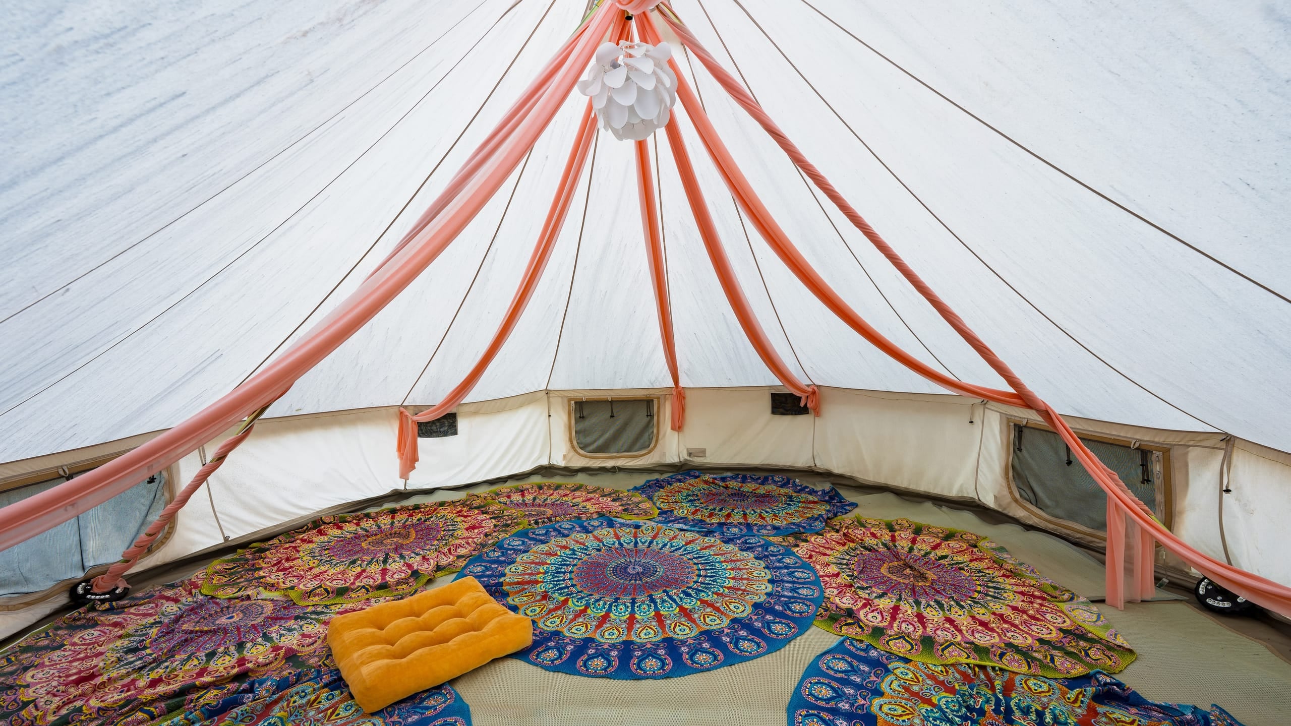 Relax inside this spacious, boho-style tent set in a serene natural landscape.