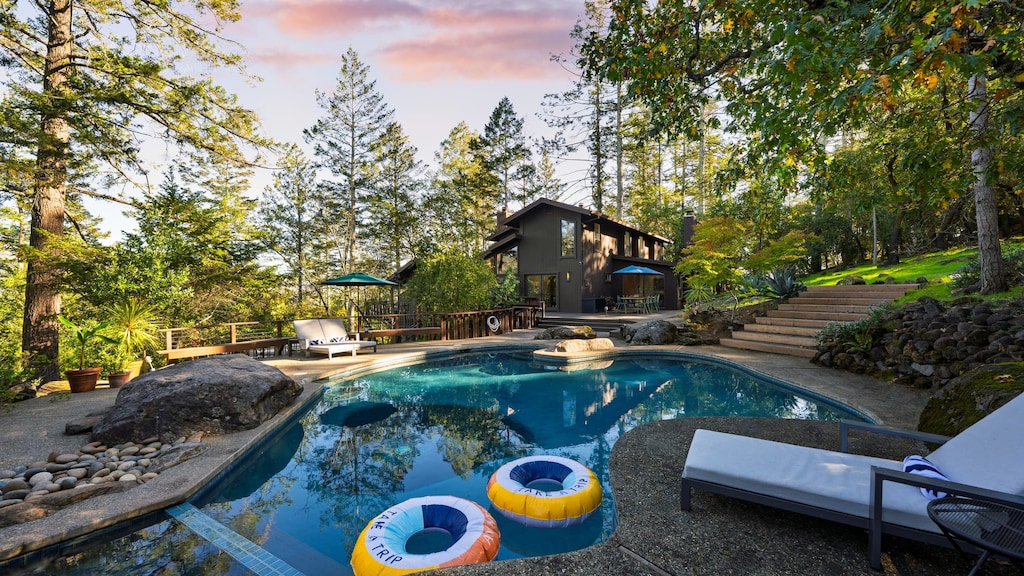 A refreshing forest escape with a sparkling pool and sun-drenched seating.