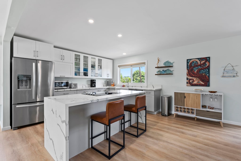 This modern kitchen is equipped with top-notch appliances and a breakfast bar.