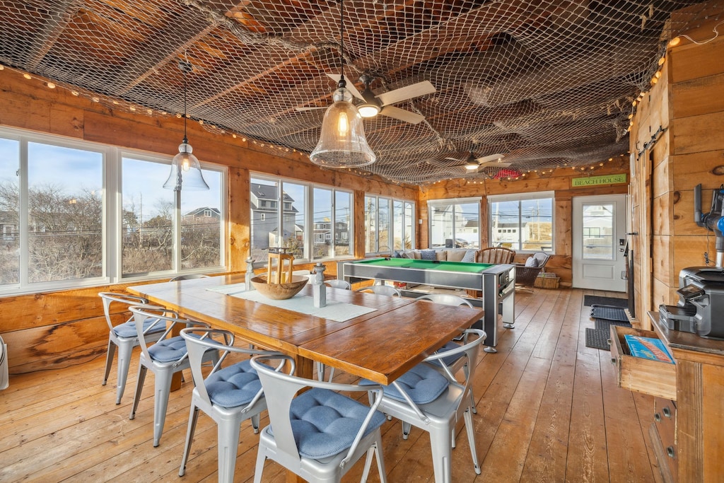 The closed in porch - this area is heated and cooled with it's own mini-split system. There is a pool/air hockey table, seating for 10 at the table, and another seating area with a sectional and chairs