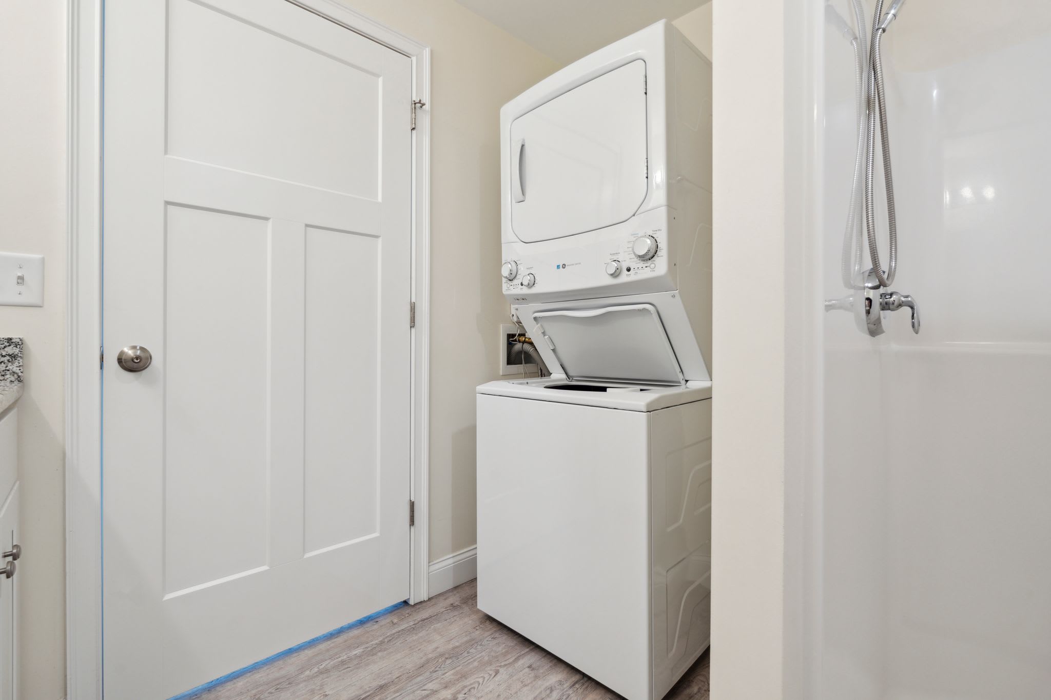 Ensuite bathroom with double vanity, standing shower, and in-unit washer dryer