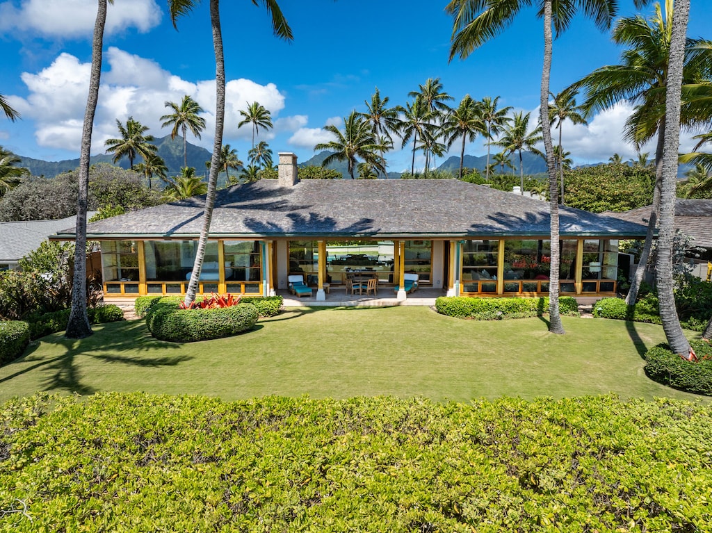 Aerial view of home with lush green lawn.