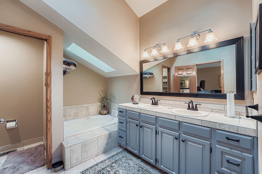 Unwind in your spacious master bathroom featuring dual vanities, soaking tub, and natural light from the skylight above.