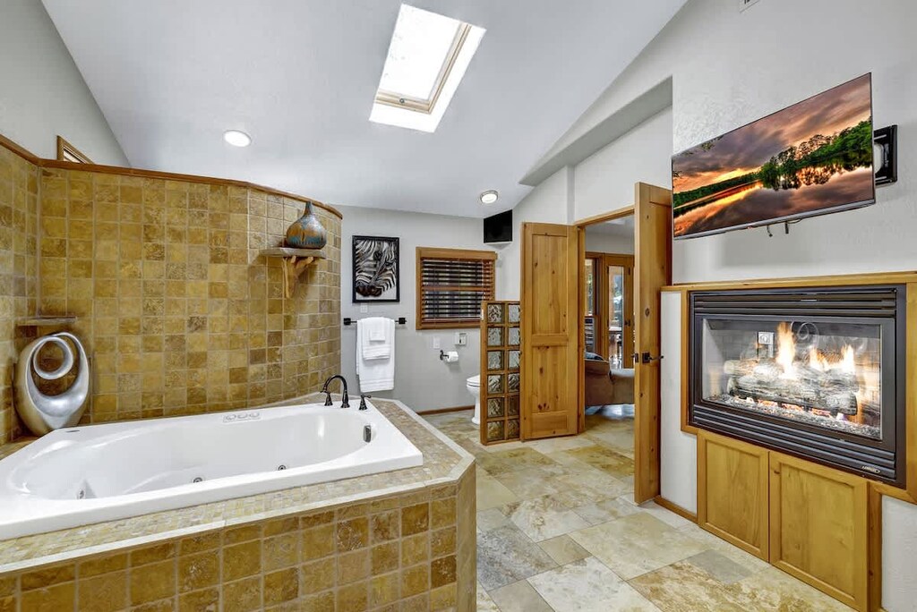 The perfect spot to unwind after a long day, the bathroom has a gas fireplace, which is viewable from the jacuzzi tub.
