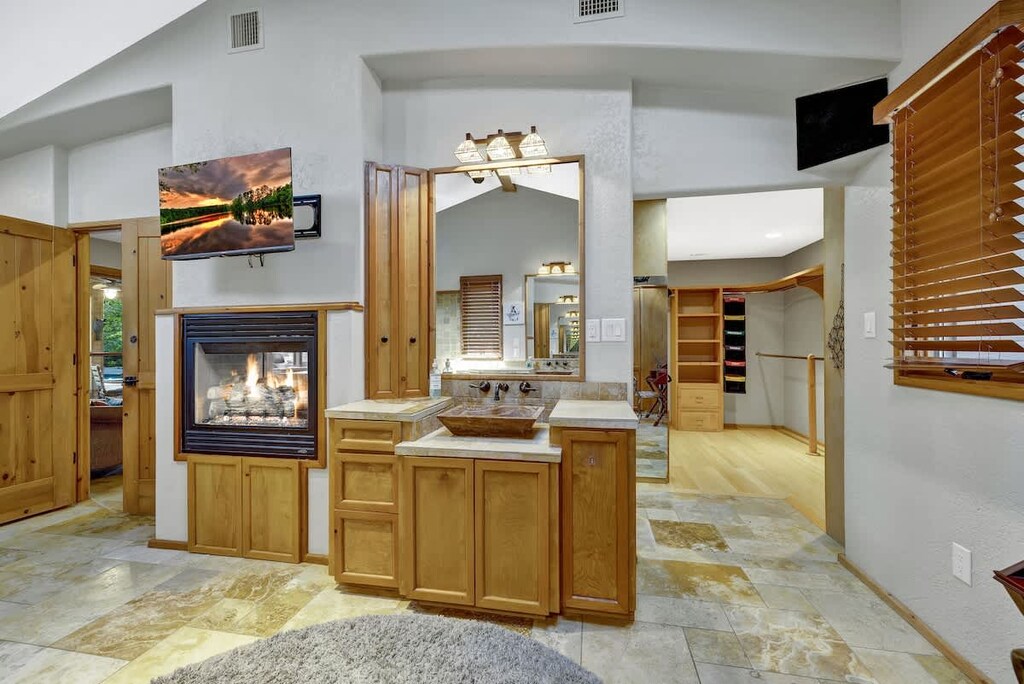 Adjacent to the vanity sink, there is a spacious walk-in closet.