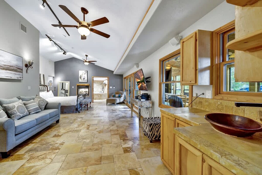 The spacious master bedroom boasts a comfortable seating area that provides a queen sleeper sofa. A perfect spot for reading, watching TV, or simply enjoying some quiet time.