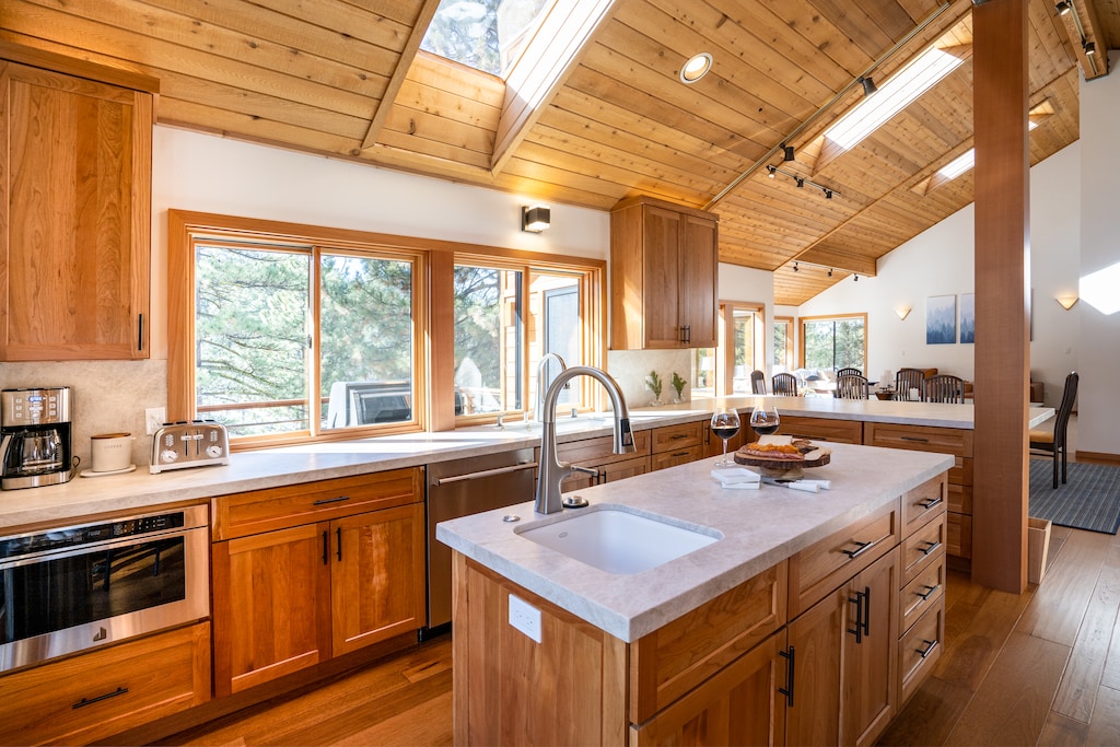 Entirely remodeled in 2021, the fully-equipped gourmet kitchen features natural stone counters, wood floors new JennAir appliances that include gas oven/range, microwave drawer, warming drawer, large refrigerator/freezer, and dishwasher. Beautiful ch