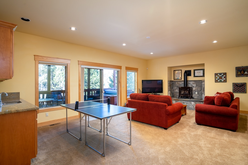 Showcasing the family room's charm with direct access to the covered deck featuring a hot tub.