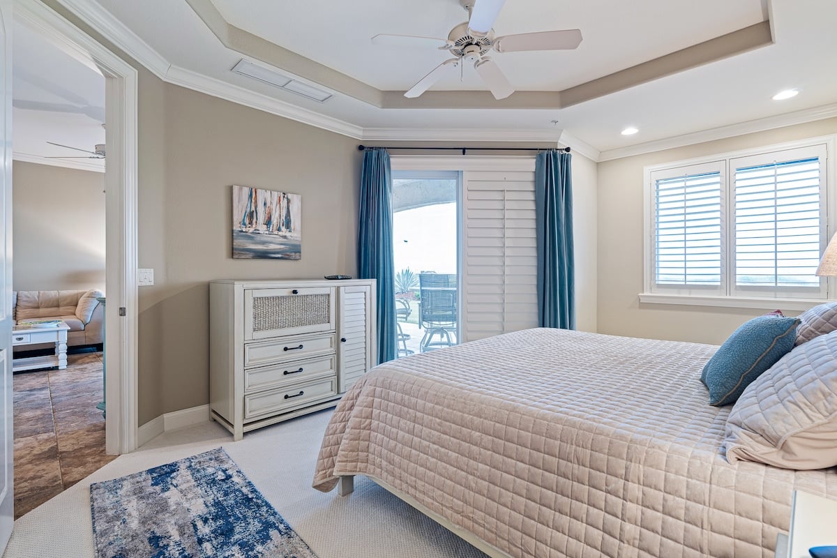 Primary bedroom. King bed & patio access. Primary bedroom. King bed & patio access.