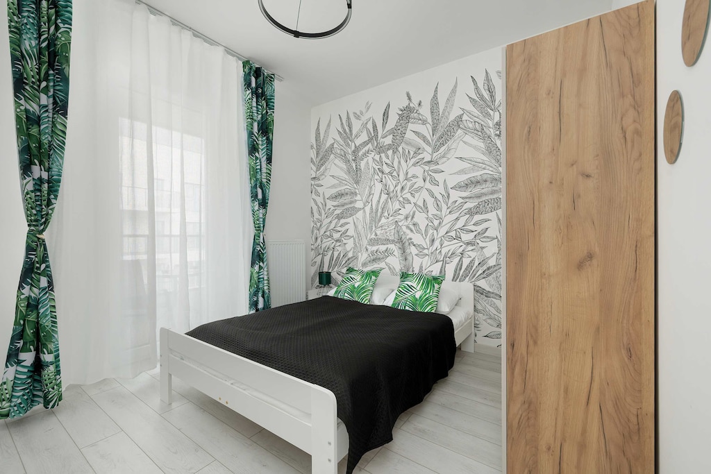 The cosy bedroom features a luxurious double bed and ample storage.