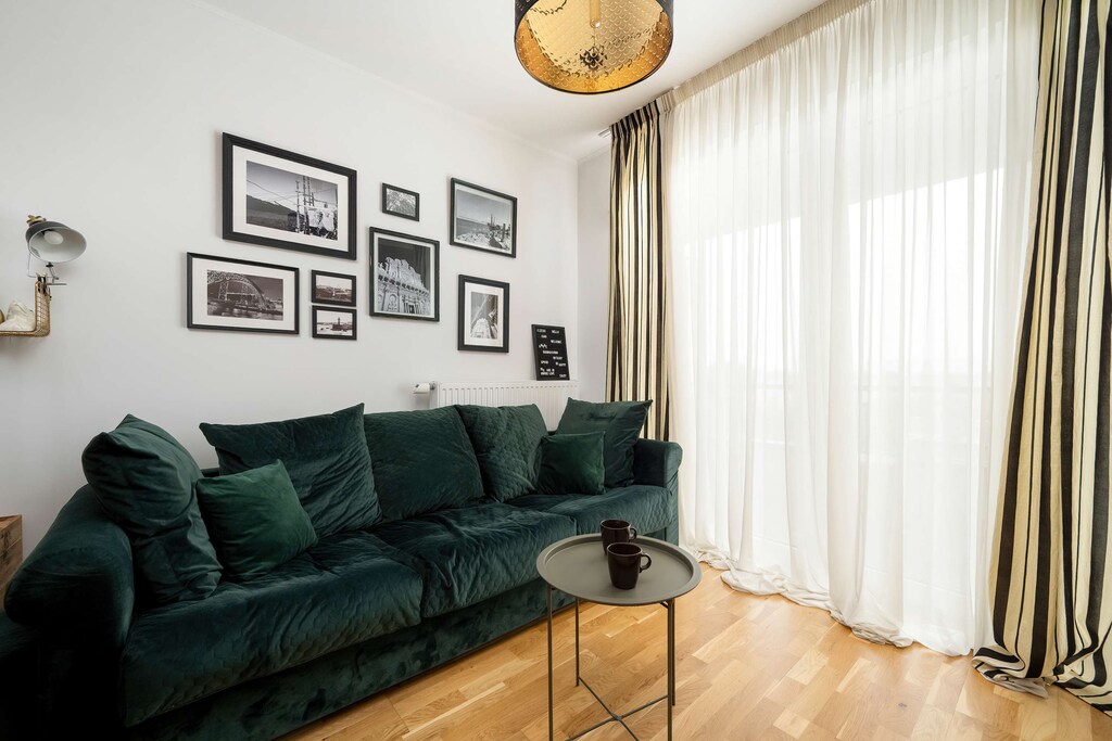 Relax in the stylish living room with a comfortable sofa and modern decor.