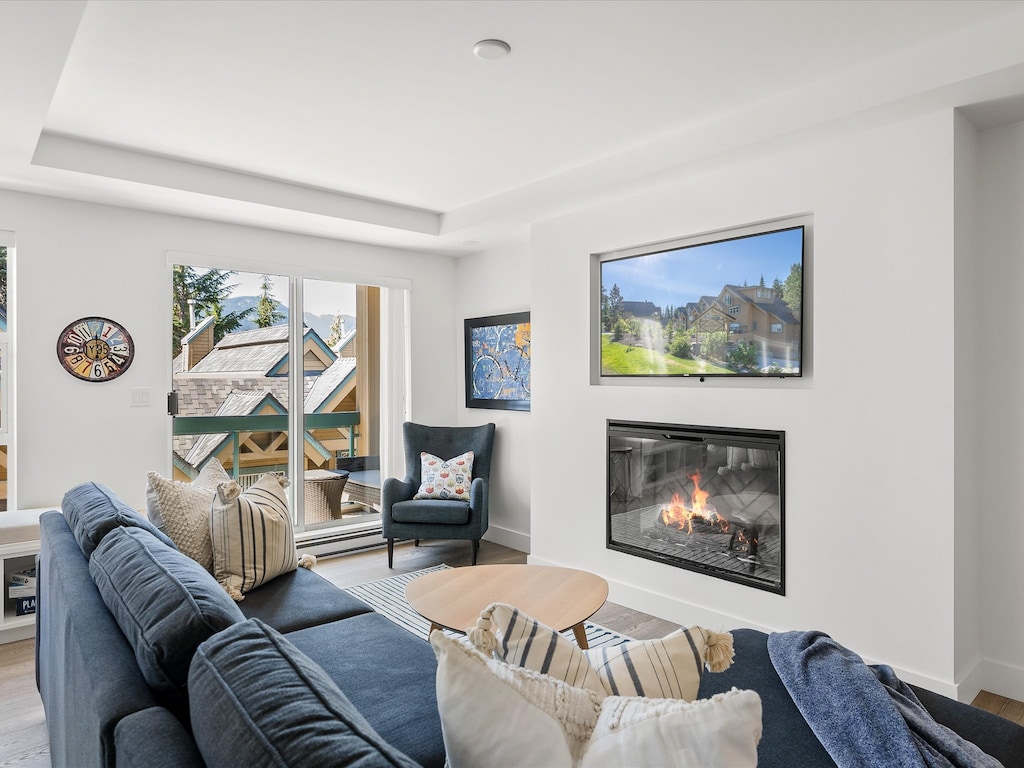 Living Room - Spacious and comfortable couch, cozy fireplace, SmartTV with cable, balcony with seating to enjoy that fresh mountain air