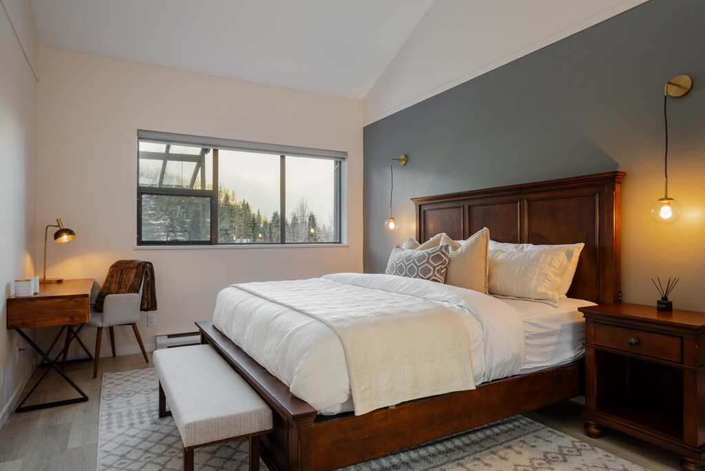 Primary Bedroom - Offering a luxurious king bed with plenty of natural light and mountain views