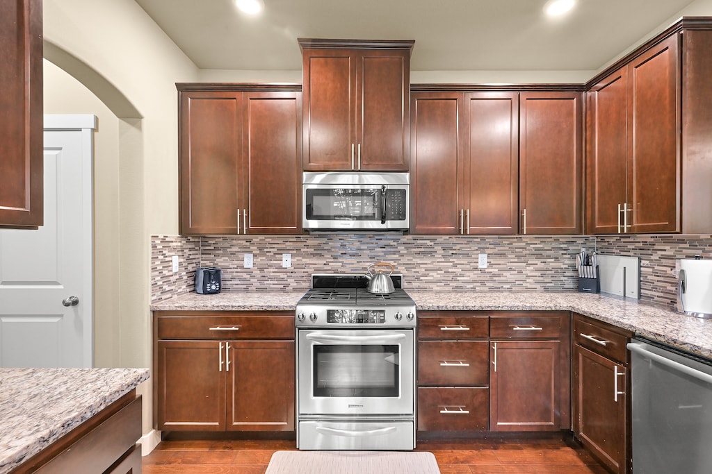 Whip up your favorite meals in the full-size kitchen featuring stainless steel appliances, granite counters, and custom cabinetry.