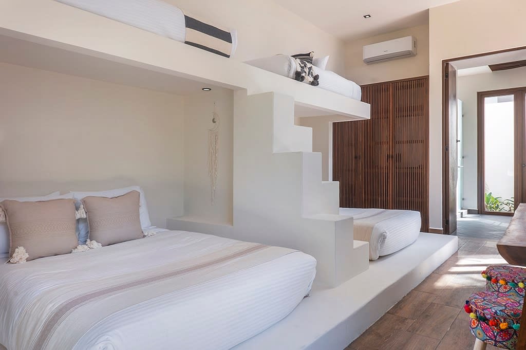 Four beds strategically positioned with modern and minimalist decor