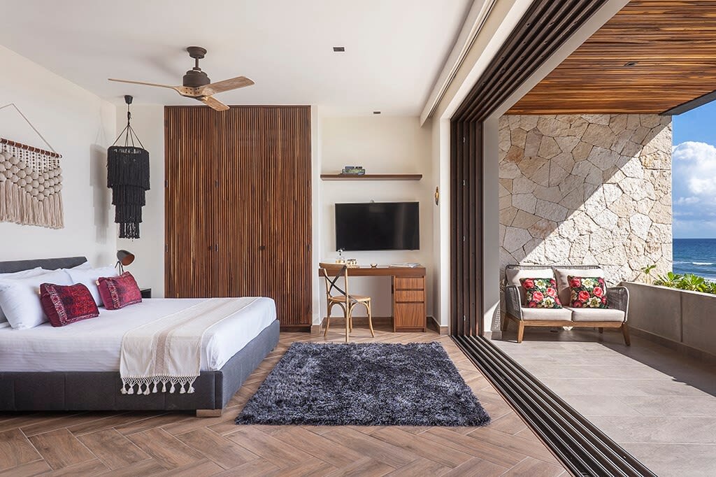 Beautiful room with a private patio. It includes a comfortable outdoor armchair.