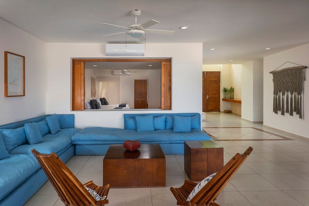 Beautiful living room with ample sofa and wooden chairs.