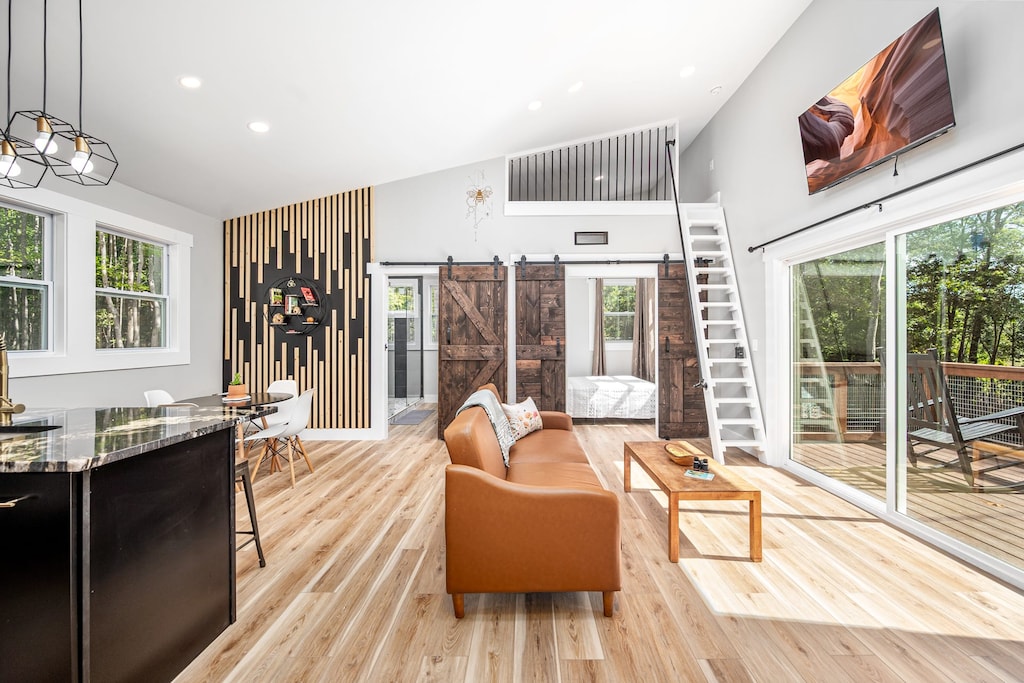 Buzz into the heart of the Beehive — a bright, open-concept space with warm tones, bee-inspired art, and easy access to the sunny deck. 