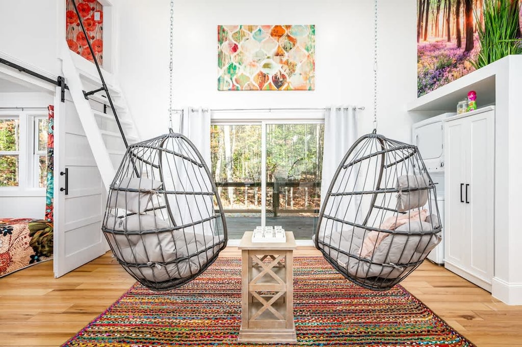 Welcome to Full Bloom’s sun-kissed lounge — featuring playful hanging chairs, garden-inspired art, and cheerful vibes perfect for relaxing or reconnecting. 🌸🌞🪴
