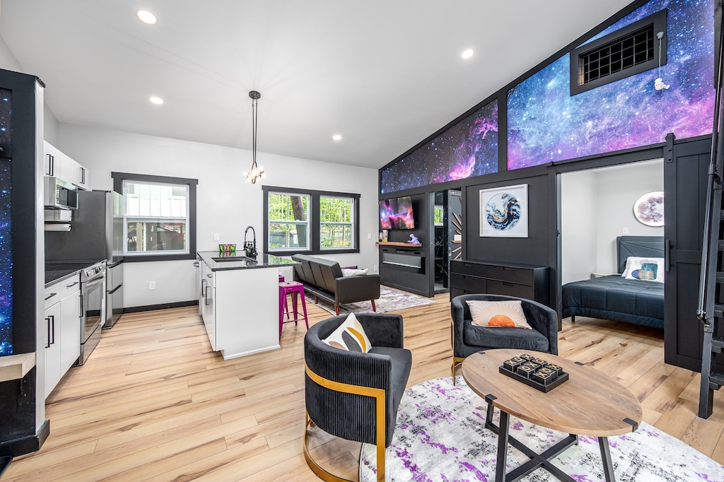 The heart of Galaxy: a cosmic-inspired living space with galaxy murals, sleek seating, and a modern kitchen ready for liftoff.