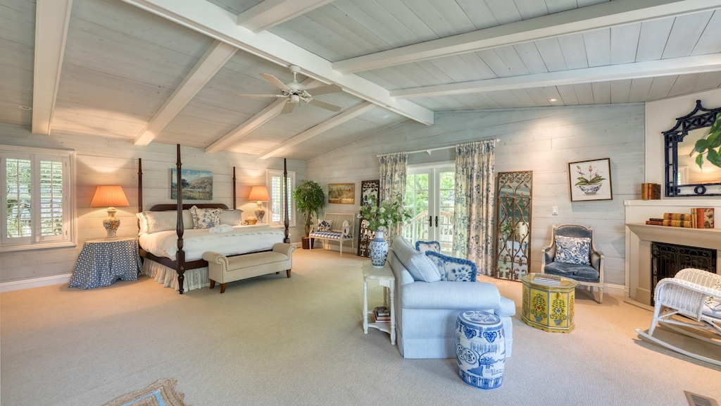 Primary bedroom suite with four-poster bed and fireplace.
