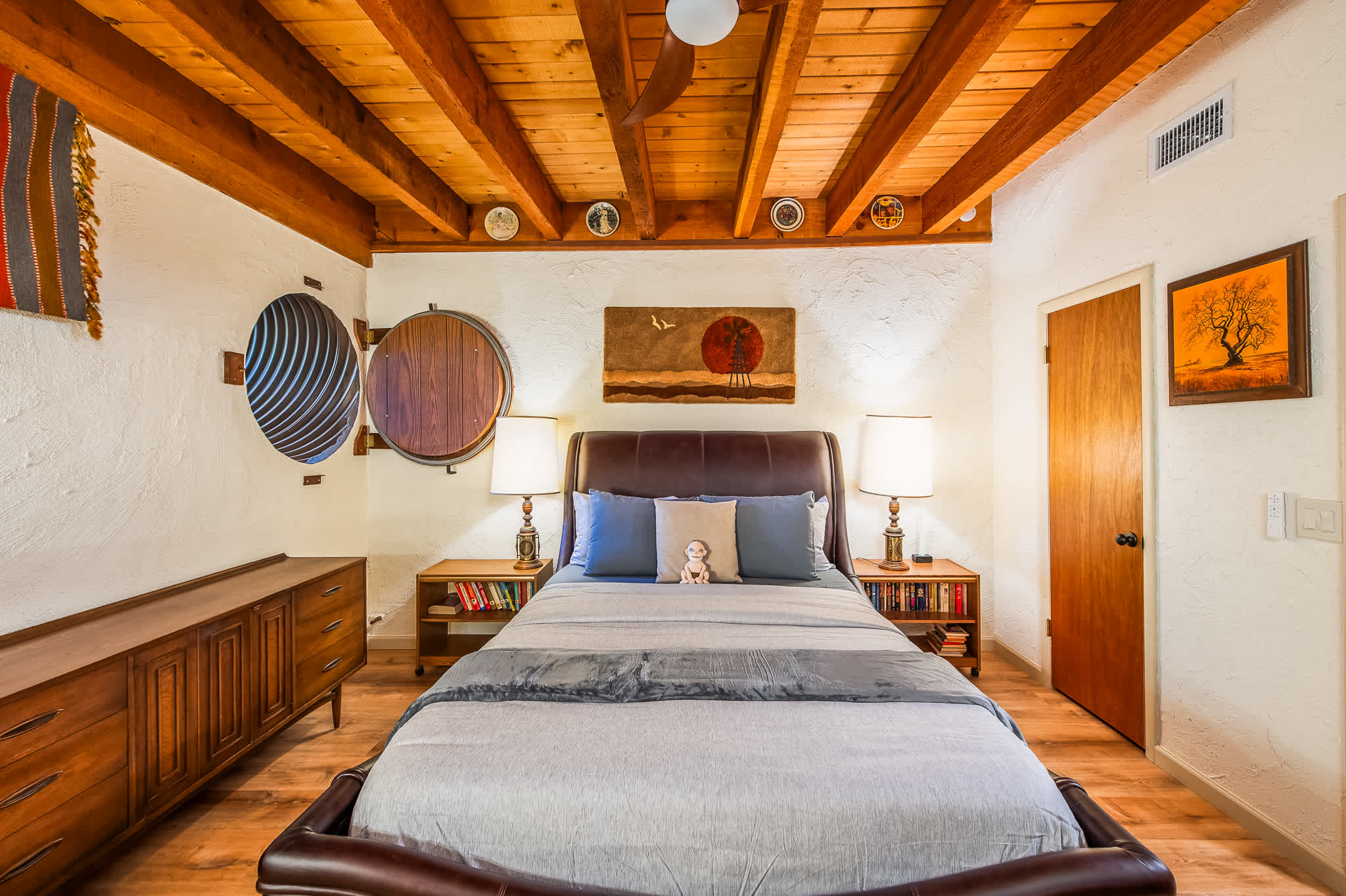 Queen Bedroom #2 | Relax in this cozy bedroom featuring a rustic beamed ceiling and warm wooden floors.