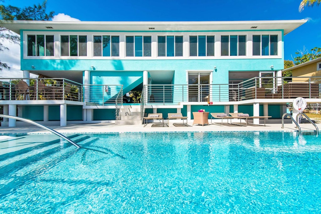 Make a splash in the home's spacious pool featuring raised terraces for alfresco dining (left) and lounging (right).