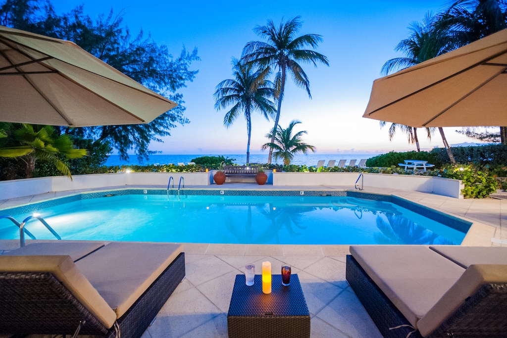 Lounge by your private pool with a stunning view of the Caribbean.