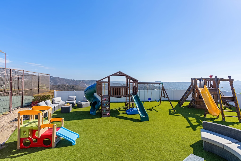 A private outdoor playground and lounge area for endless family fun, complete with a play structure, swings, and slides.