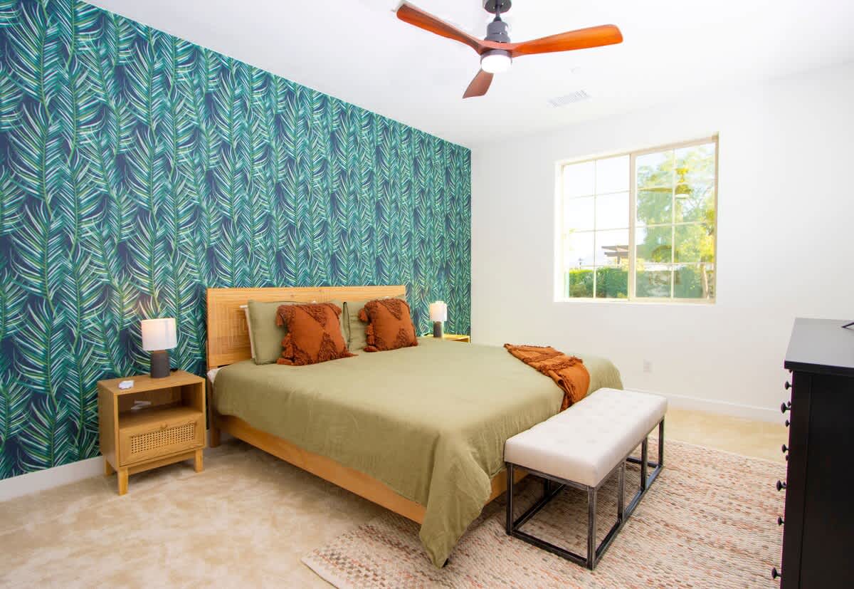 Relax in the comfortable bed of this spacious master suite.