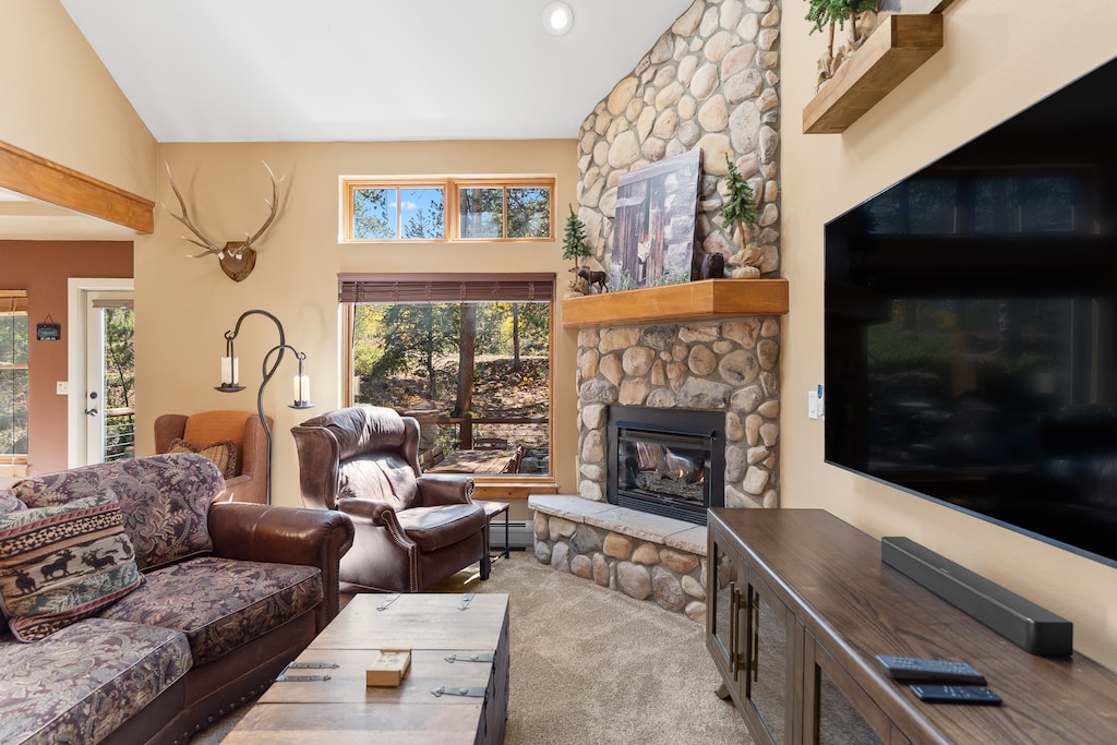 The living area features a flat-screen TV, and a fireplace. 