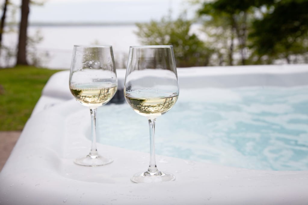Sip wine while soaking under the stars with lake views.