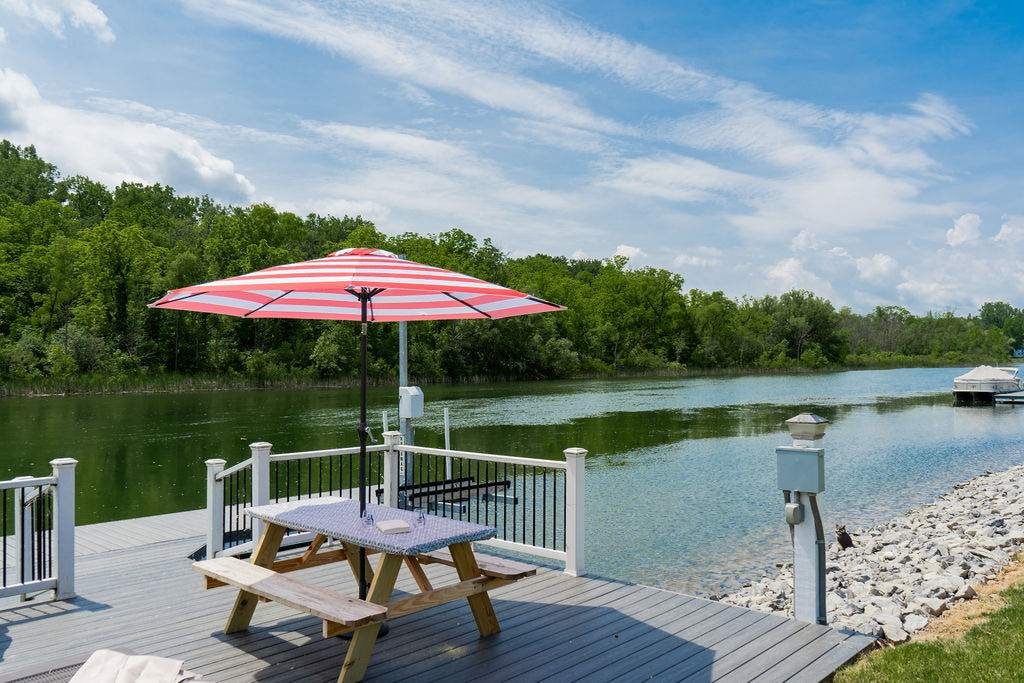 Just a quick stroll to relax by the water on your private dock with seating, umbrella, and stunning views.