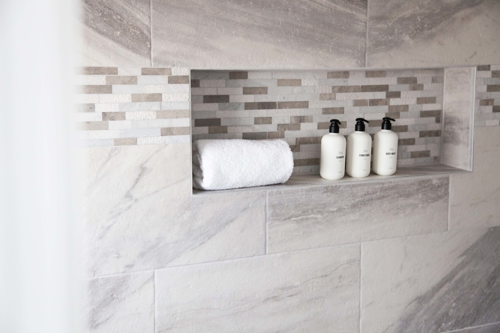  Luxurious tile and spa-style shelving with plush towels