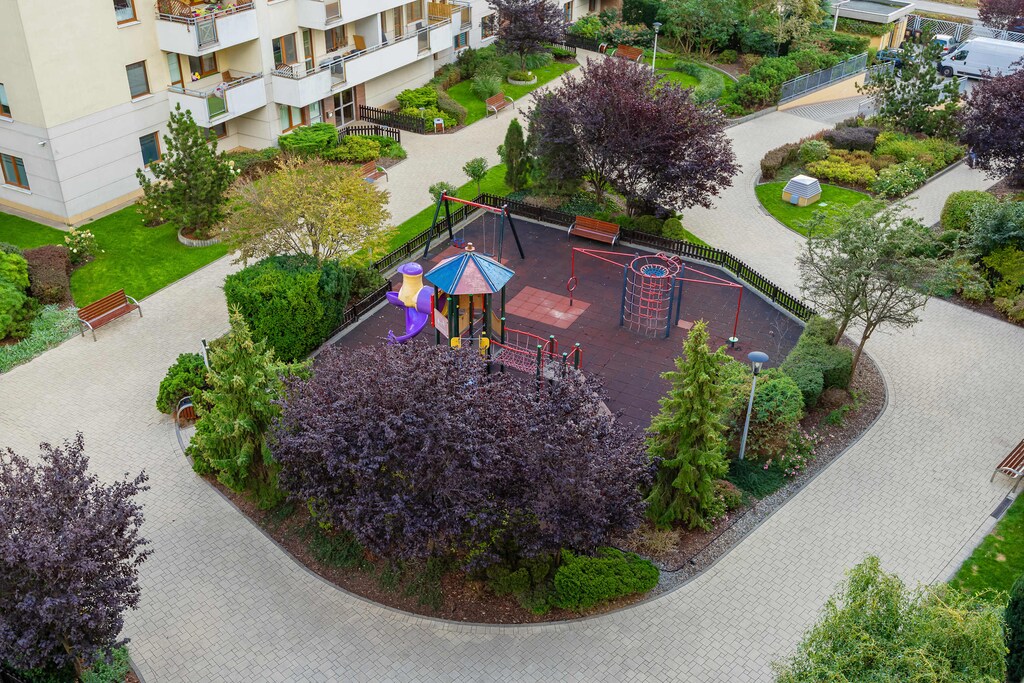 A well-kept courtyard with a playground and greenery lets you enjoy outdoor moments surrounded by nature.
