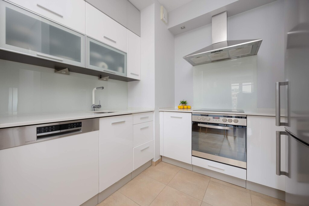 A modern kitchen with full equipment offers convenience for cooking and plenty of storage space.