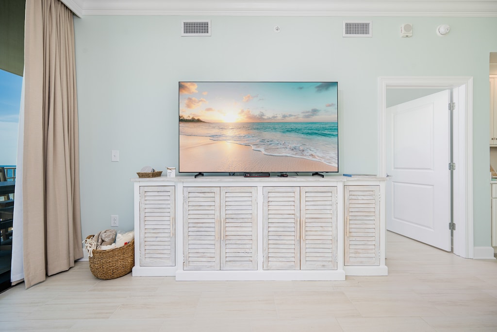 Enjoy the spacious living area with a large TV and stylish cabinet, perfect for relaxing after a day of fun