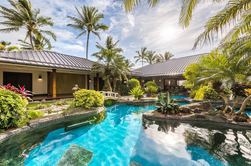Relax poolside beside a beautiful pool and cascading spa waterfall, framed by panoramic ocean views.