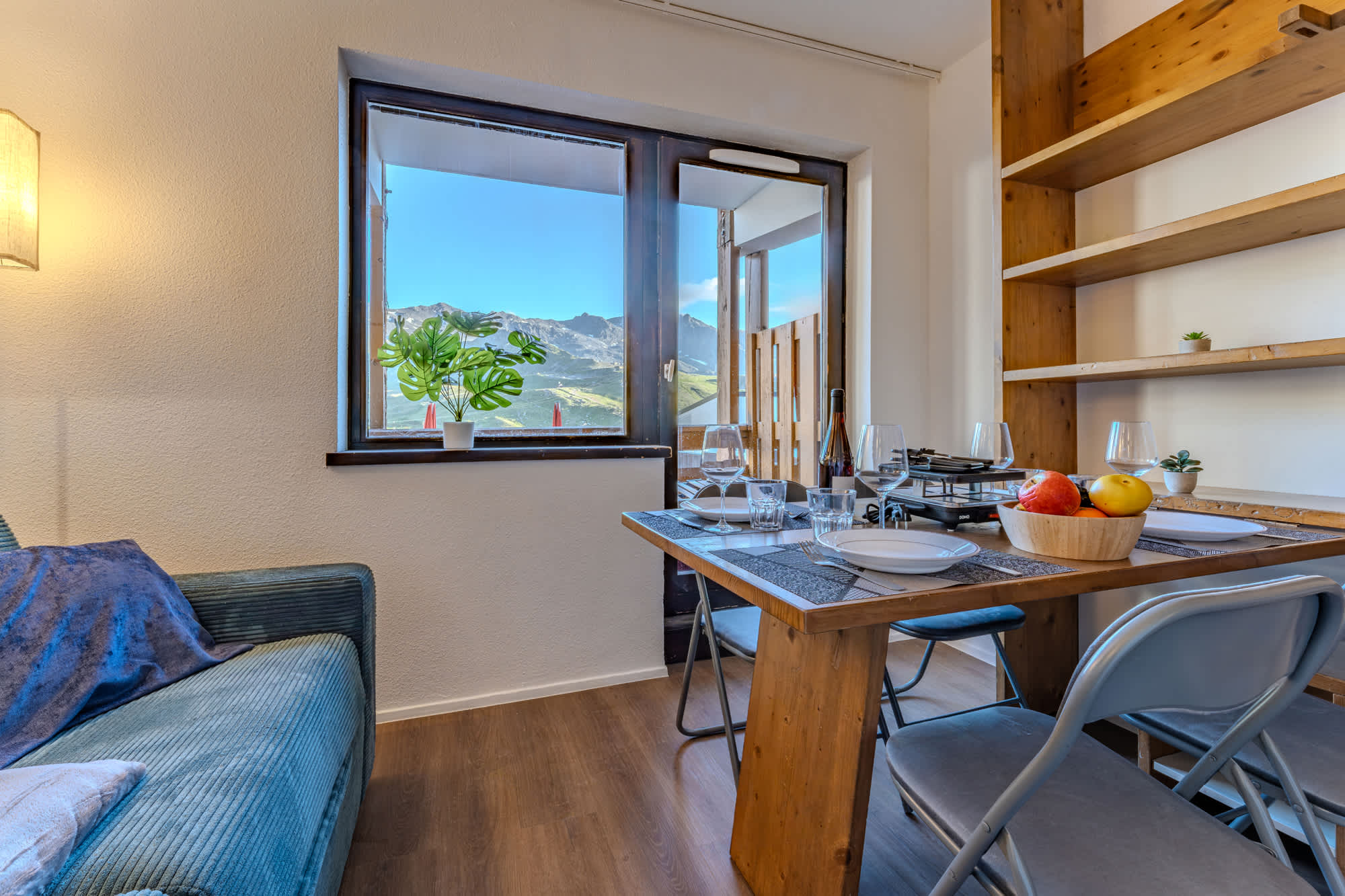 Unwind in a snug living area with a comfortable sofa bed, soft lighting, and modern mountain-style décor