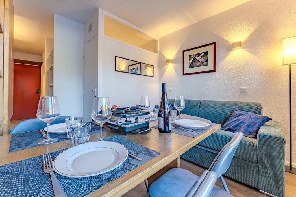 Experience the essence of a French Alps holiday — a raclette feast, wine, and a cozy table for four with picture-perfect views.